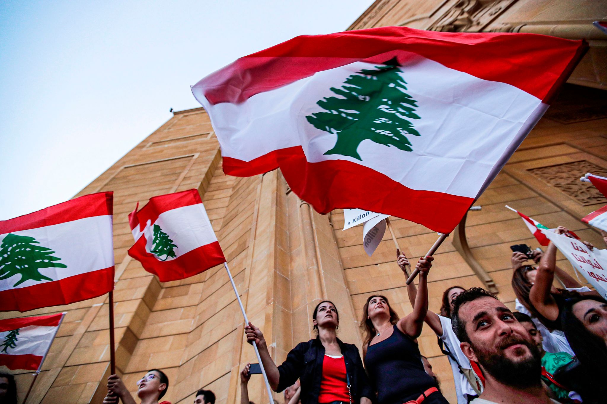 Lebanese demonstrators wave national flags