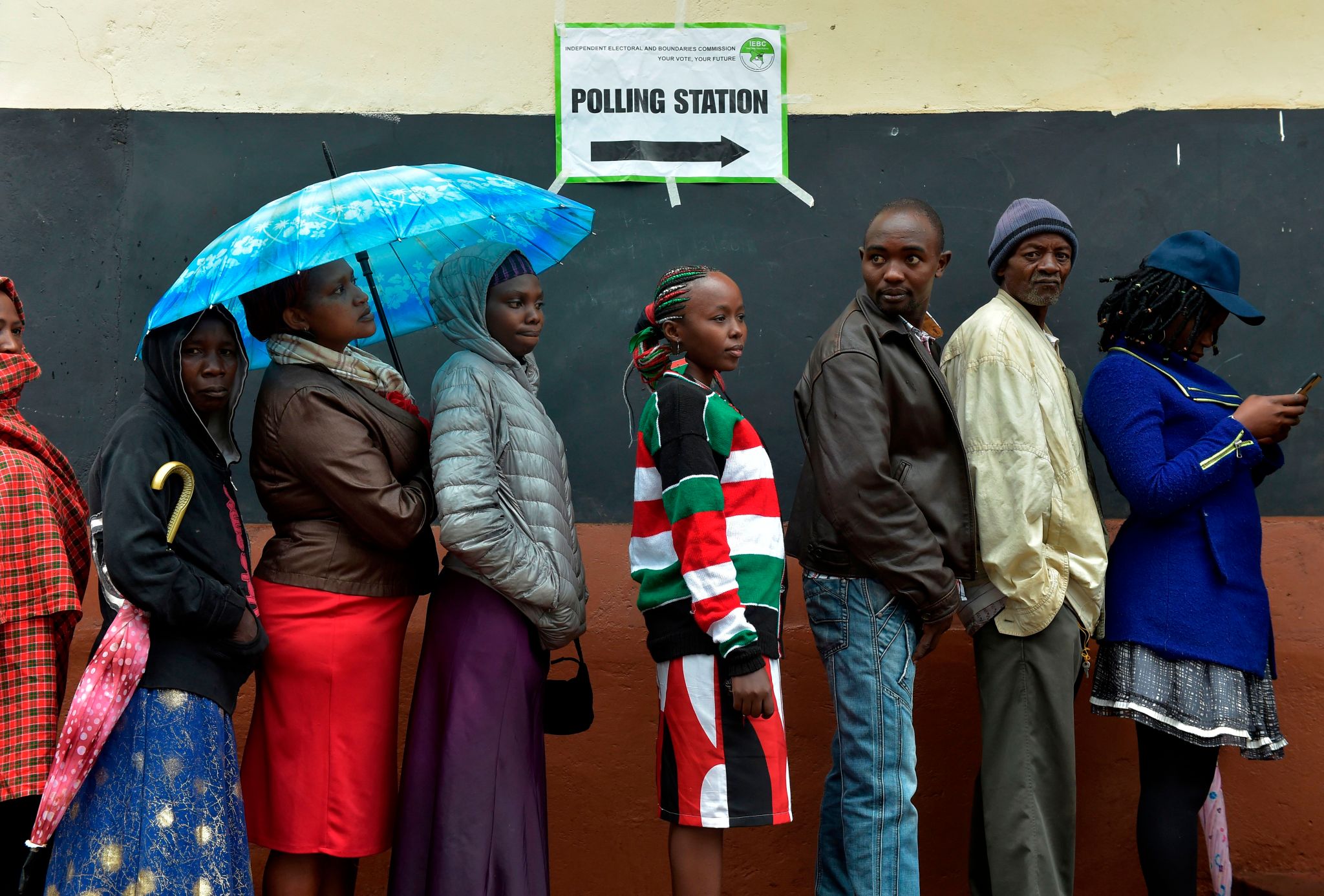 Voters queue at a polling station